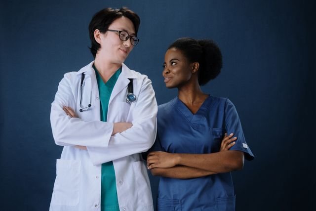 Diverse medical team in uniforms with stethoscopes, conveying teamwork and professionalism.